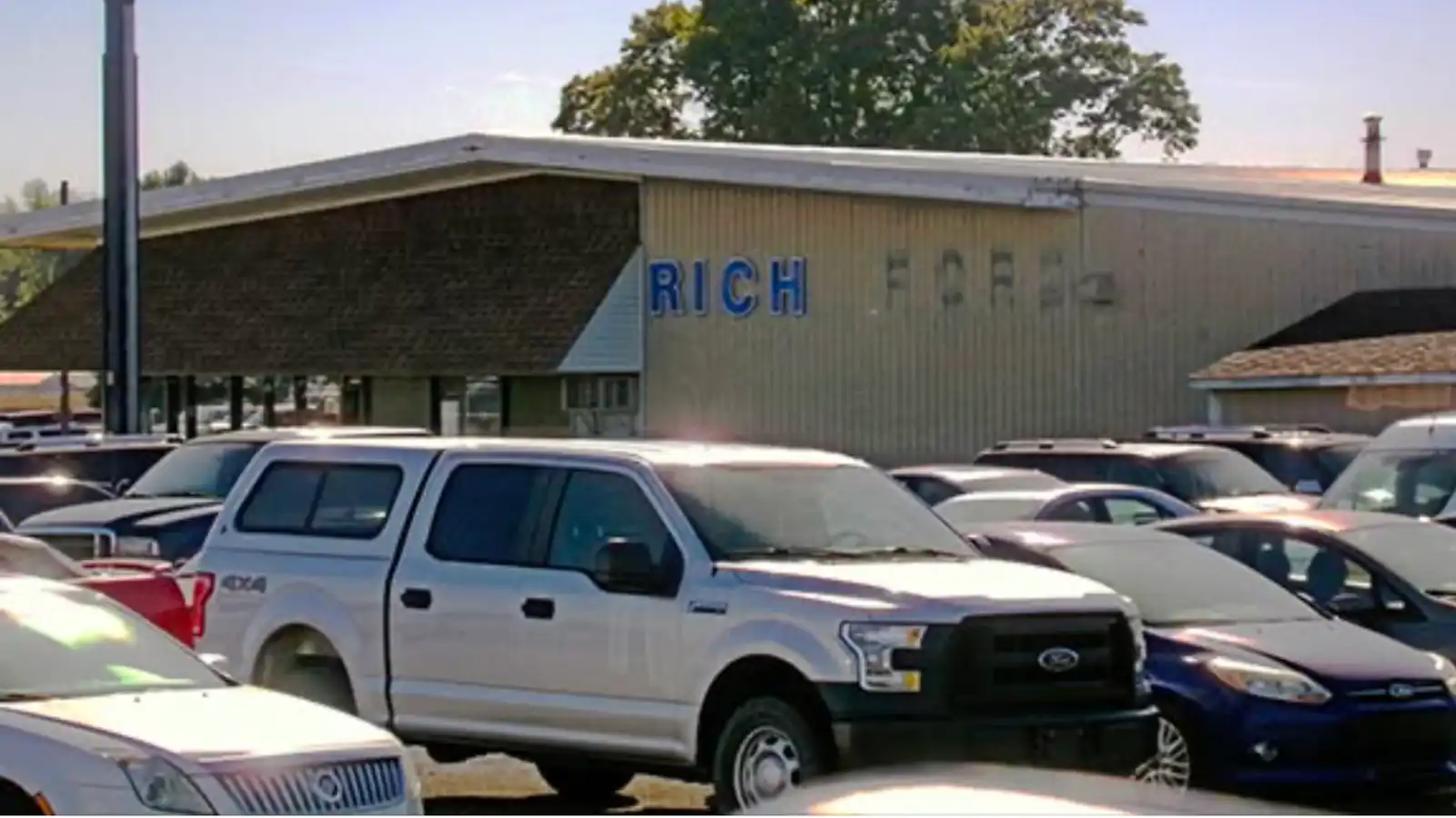 Picture of the Roland Rick automobile dealership with the word Ford removed