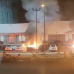 cars burning in a Tesla dealership