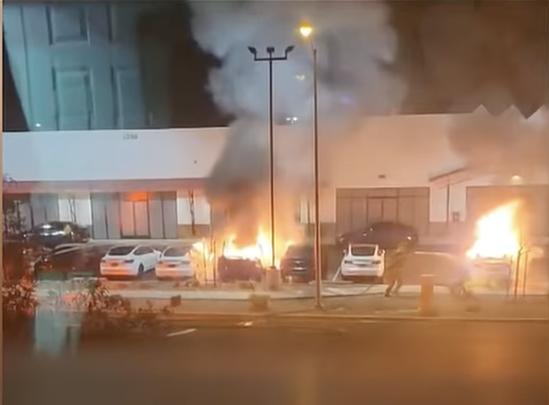 cars burning in a Tesla dealership